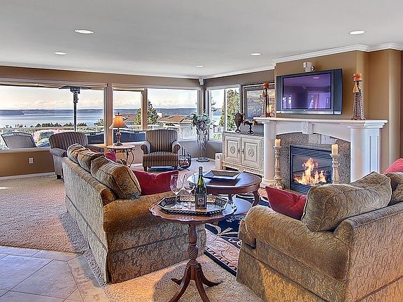 The large great room boasts oversized picture windows that capture the magnifi