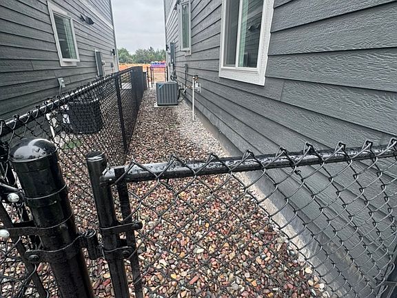 fenced side yard with gate entry on each end