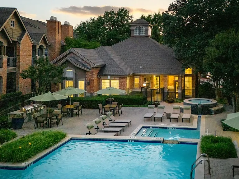 Swimming pool and sundeck with picnic tables