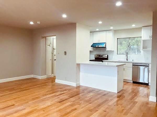 Newly renovated kitchen w/ bar area and pantry (not pictured). 
Open floor plan. Perfect for entertaining!

Note: Range hood is not blue. It is blue plastic film that was part of the packaging that was later removed.