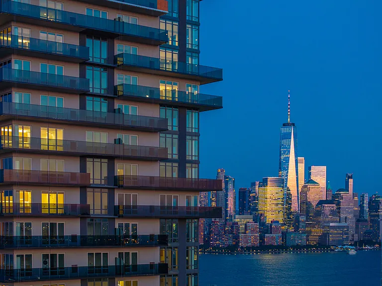 Marvel at the stunning nighttime skyline with views stretching across Manhattan and Jersey City