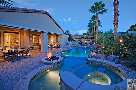 Fantasy backyard faces South.  Pavers, salt-water pool, spa, tanning shelf, cascading rock waterfall, fire pit, sunscreens, outdoor BBQ (under palapa), and several seating areas.
