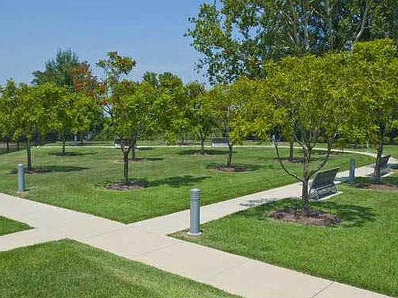 Outside gardens, includes dog park, tennis/pickleball courts, vegetable garden, grills.