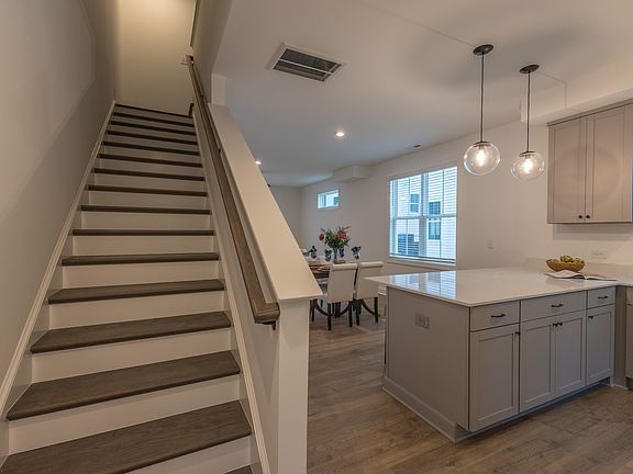 Entrance hallway includes a coat closet and a bench with hooks for coats & jackets