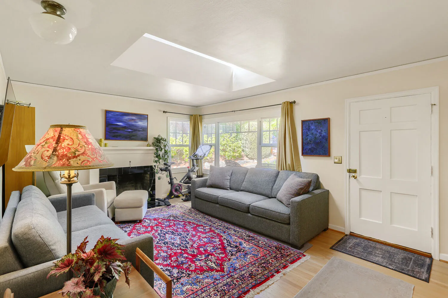 Living room with skylight and hardwood floors