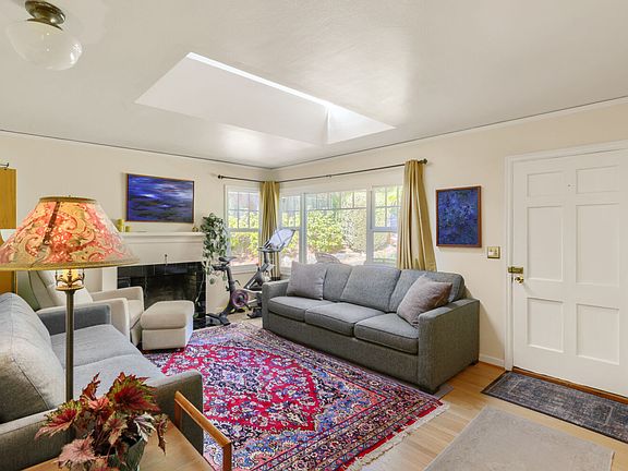 Living room with skylight and hardwood floors