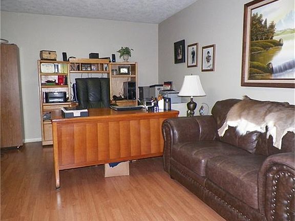 The formal living room is currently being used as a study.