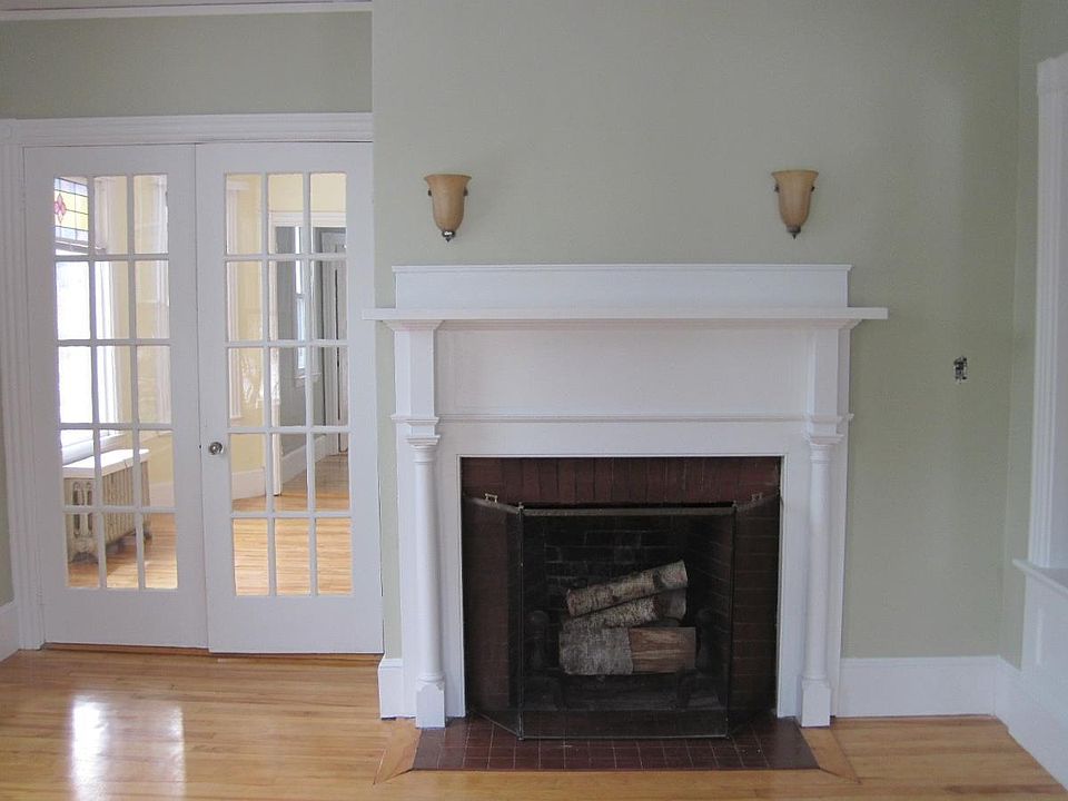 fireplace and french doors living room leading to dining roo