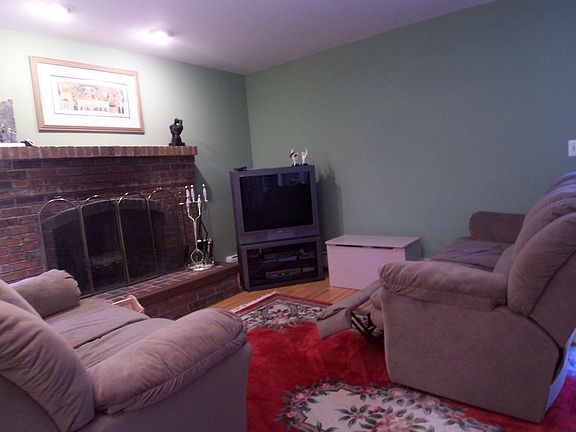 Warm and cozy family room with brick fireplace