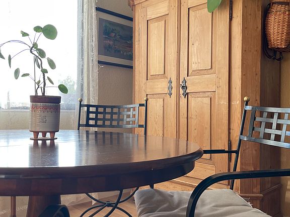 Eating nook armoire that holds glassware, vases, toaster, platters, and other less used kitchen/tableware items.