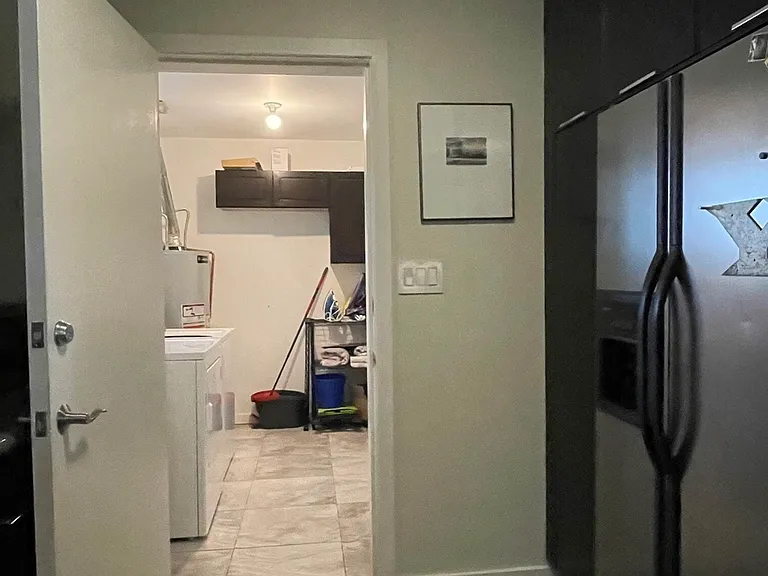 Kitchen to laundry room, entrance to garage