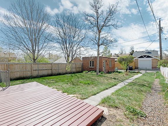 Back patio and garage. New fence being installed on south side of lot.