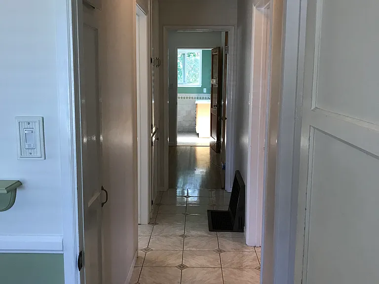 Hallway view from second bedroom to master bedroom and bath. Two closets provide ample storage.