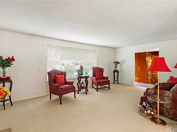 Formal living area with large window, blinds, electric fireplace and much more!