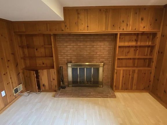 Entry to the office with window to the left of the fire place