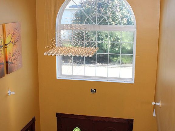 Foyer view from above with designer chandelier with crystal
