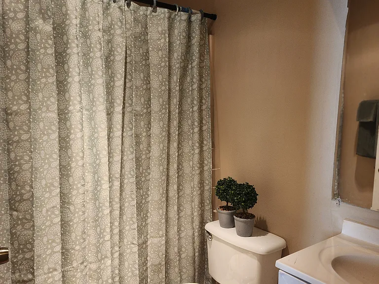 Full bath. Tub and shower with single vanity.