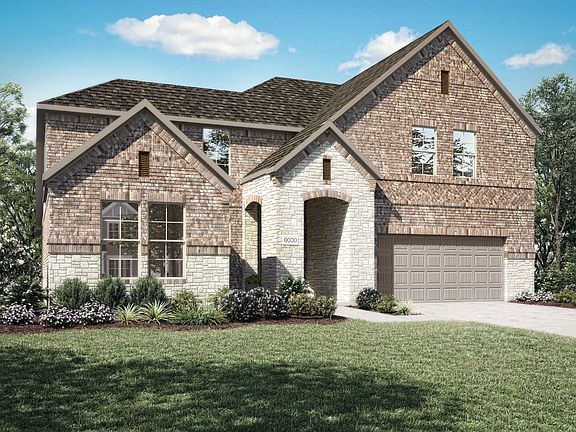 Elevation C is a traditional two story brick and stone home design with arched entry at front porch.