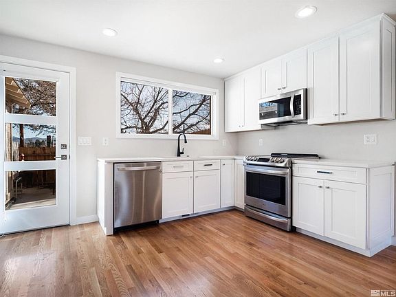Kitchen with dishwasher and electric range oven.