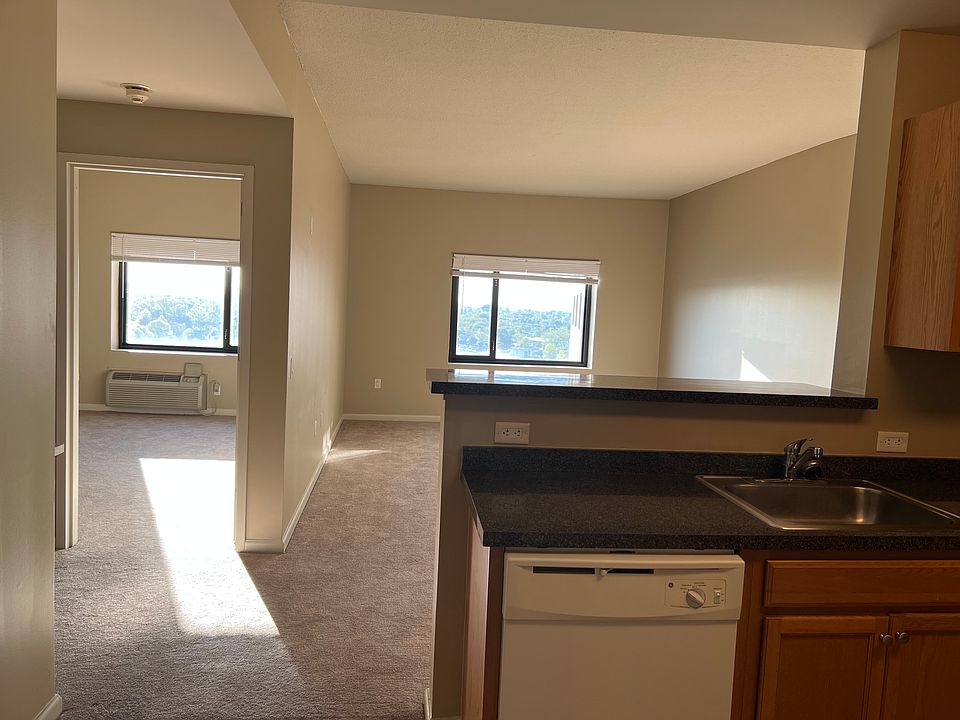 Kitchen counter and breakfast bar, living room, and bedroom