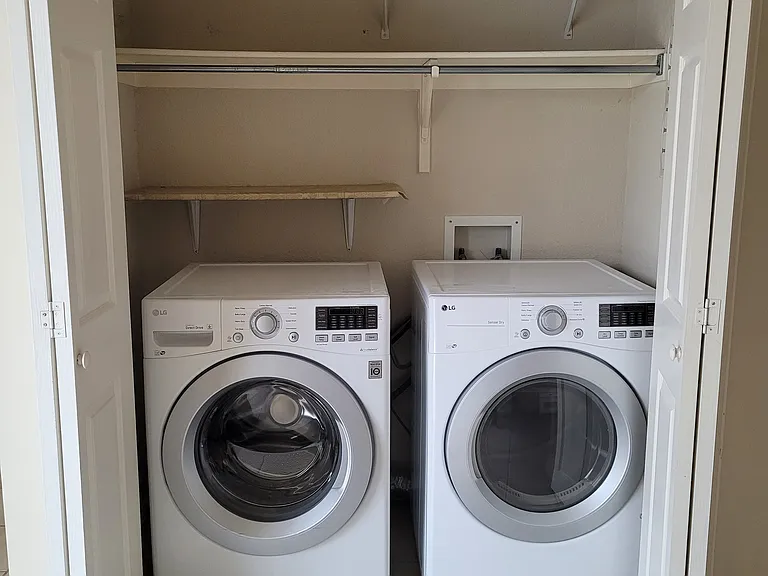 laundry next to kitchen - front loading washer and dryer