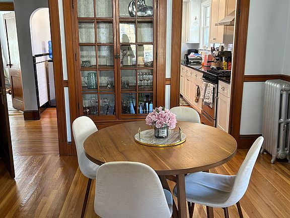 Dining room with hardwood floors and hutch.