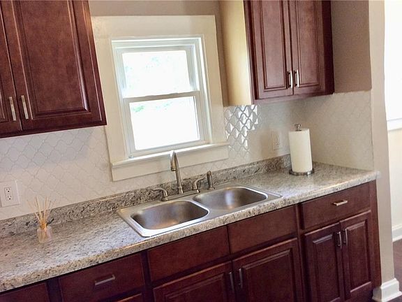 Kitchen features new cabinets, counter tops and stainless sink.
