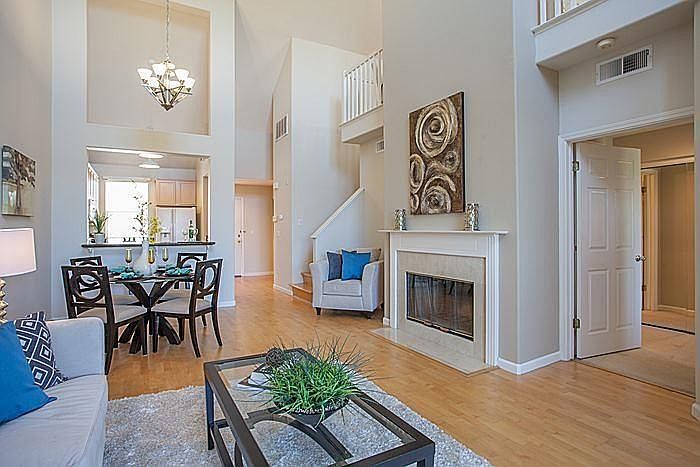 Family and Dining room area. It's an open Floor Plan with Cathedral ceiling. The condo is airy with lots of sunlight. Stairs by the fireplace leads to the a den/loft with storage space.