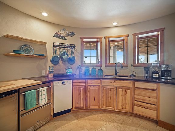 Beautifully styled round kitchen with fridge, freezer, dishwasher and wine cooler below the counters.
