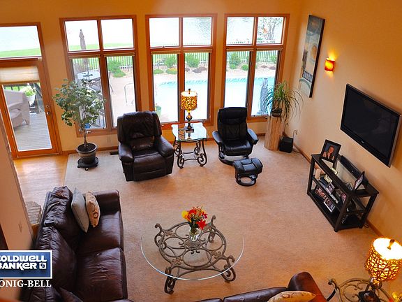 Impressive Living Room overlooks in-ground swimming pool, deck & pond