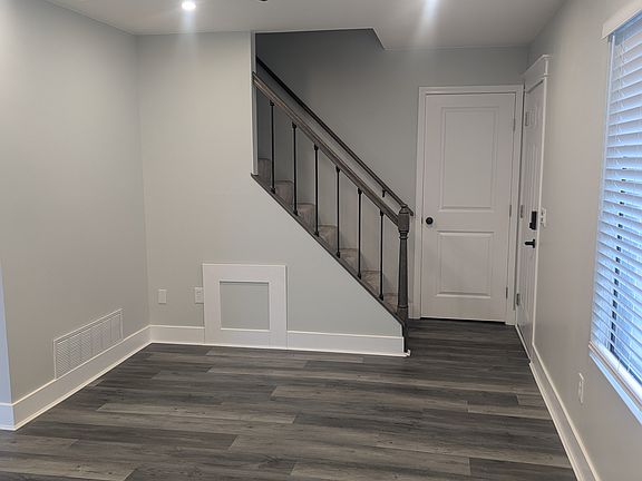 view from the living room facing the stairway (front door is visible on the right)