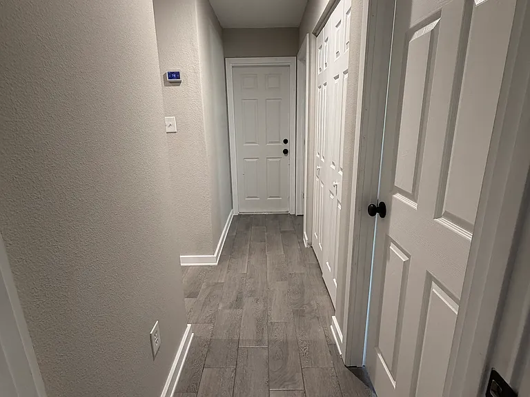 Hallway entry to garage, laundry room, guest bath, guest bedroom