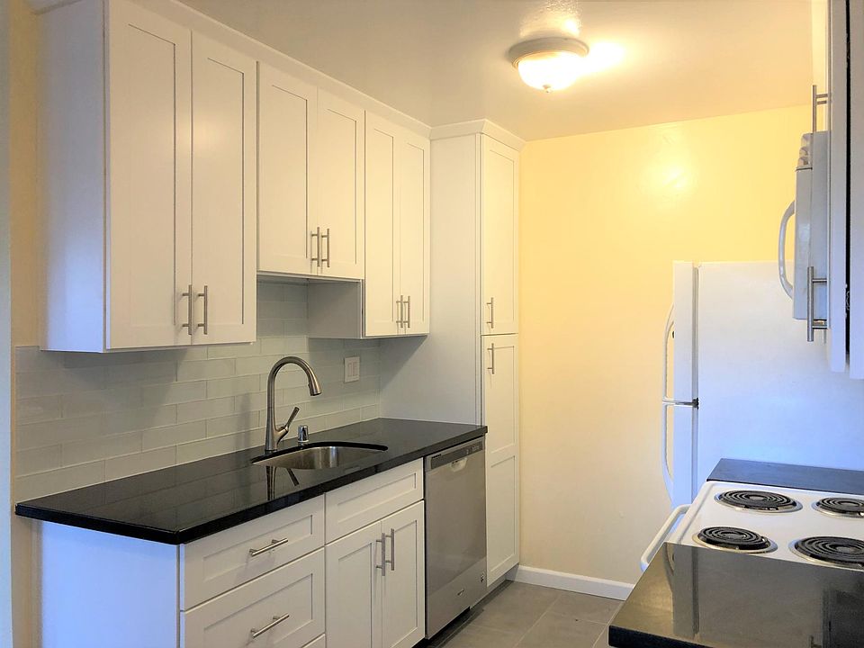Remodeled kitchen with Shaker cabinets, quartz countertop, and European-style backsplash