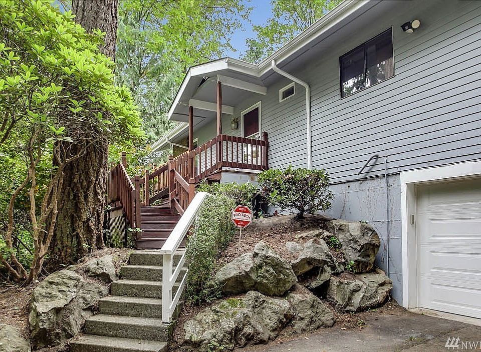 Welcome home to Carriage Lane! This 3 bedroom plus bonus, 3 bath home sits nestled in the woods in this well-established neighborhood. Boasting a near-half acre lot, you'll feel like you're at a private retreat. The living room features soaring vaulted ceilings and a stunning wall of windows looking out into the trees. Cozy up to the fireplace and enjoy connecting with guests in the open concept living and dining rooms. The kitchen features white cabinets and stainless steel appliances. On the main floor you'll also find the master with ensuite bath and a French door to the deck, plus 2 additional guestrooms and full bath. Many features add character to this home! The lower level boasts a spacious family room with cozy wood burning fireplace insert and a bonus room. Enjoy ample storage here.  Escape to this secluded property! Award winning Kent Schools. 