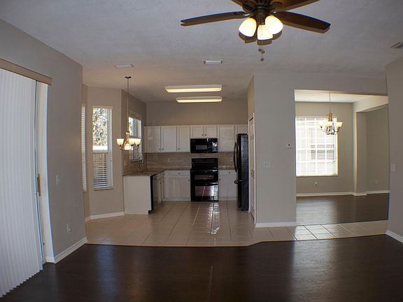 View is from family room looking toward kitchen and dining room. On the left you see the sliding glass door leading to the covered patio and backyard.