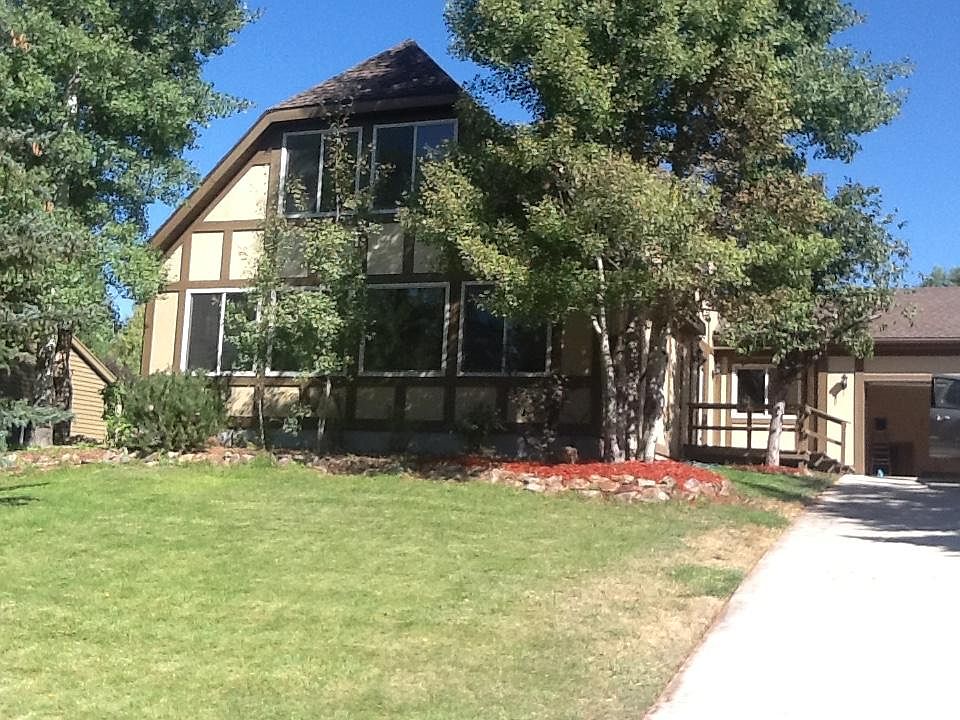 Front yard with entry porch, off street parking, and large two car garage with storage.