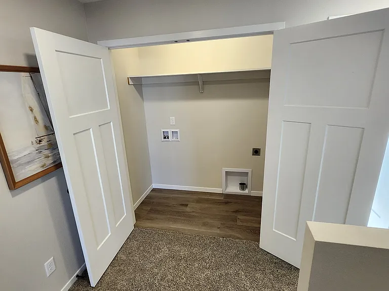 Laundry space directly off the upstairs landing (washer/dryer not pictured but provided). (Pictures are of another unit with similar finishes and features.)