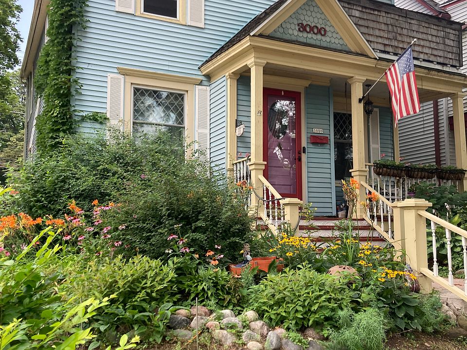 Front view of house, apartment porch above flag