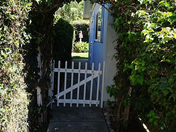 picturesque entryway with white picket fence