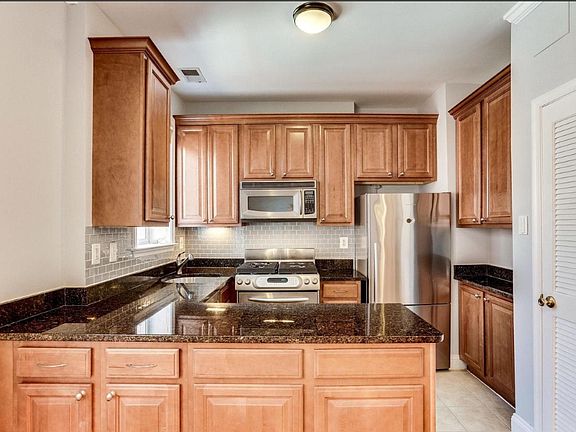 Fully equipped kitchen with full-size washer/dryer enclosed in a closet
