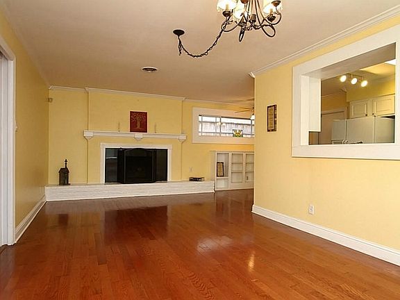 The den has wood floors & crown molding..