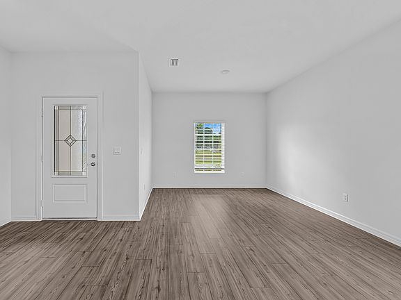 As you enter you are welcomed by a flex area and dinning room