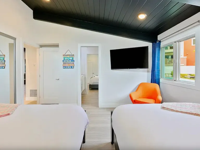 4th Bedroom with Two Queen Beds, TV and Shared Jack and Jill Bathroom.