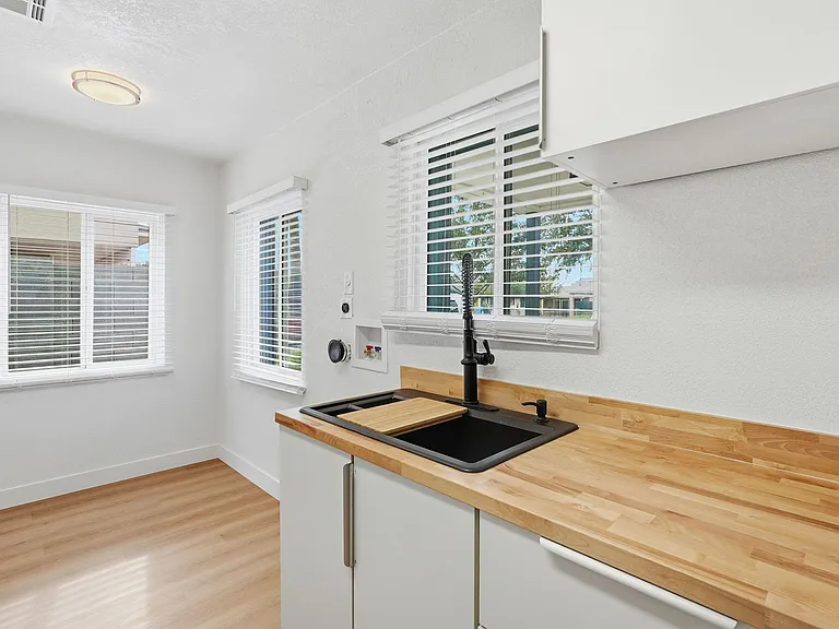 Kitchen with large farmhouse sink and designated dining space. Lots of natural light all day.