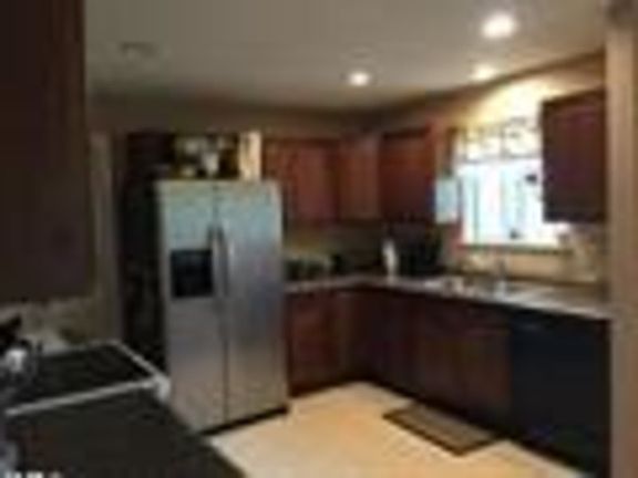 A total remodel, includes new cabinetry, counter tops, appliances, tiled backsplash and recessed lighting