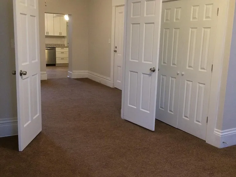 View from bedroom into living room and kitchen