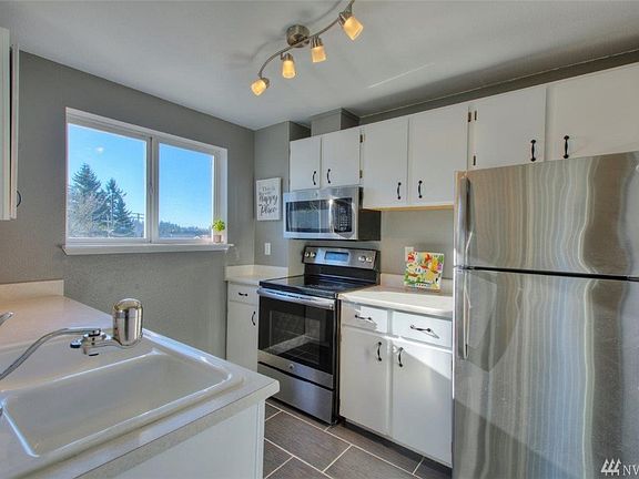 Nice tile floor and stainless appliances. 