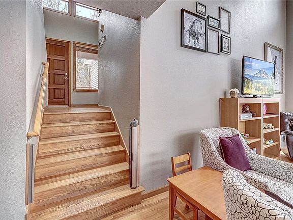The front entrance is welcomed by hardwood floors that lead down to the living room. 
