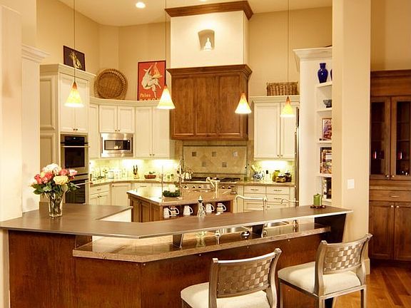 Gormet kitchen with granite slab counters, center island with sink