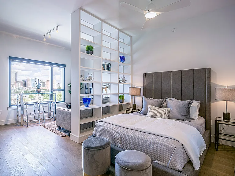 Spacious and Bright Studio Apartment with Built-In Shelving Divider